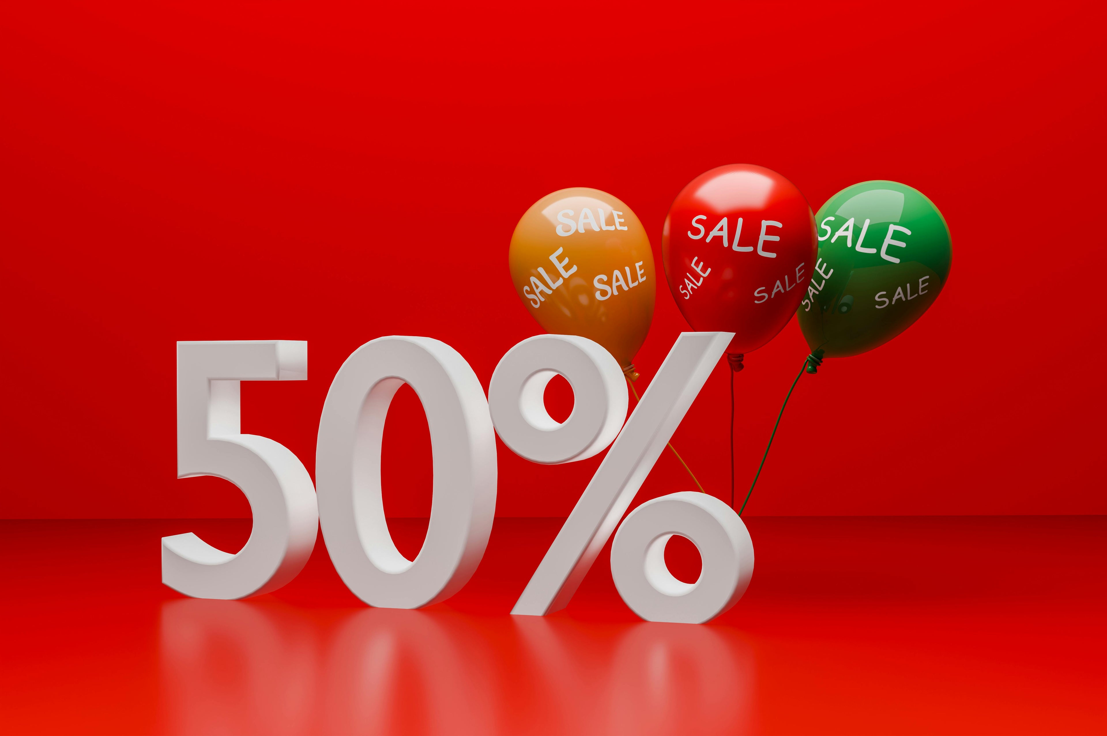 50% sale text with colorful balloons on a red background